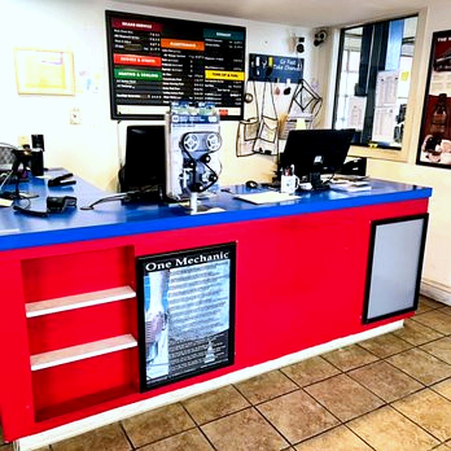The front desk inside Nationwide Auto Repair, with the full service menu posted on the wall